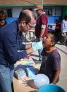 Irvine Rotarian Ray Benedicktus applies fluoride treatment
