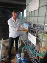 Dr. Moses Presents Rotary Flag with Water Unit